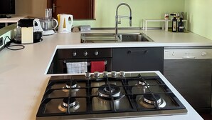 A modern kitchen with a gas stove, stainless steel appliances, and a built-in dishwasher. - A Getaway in Nature: Lakes & Golf (Bogogno)