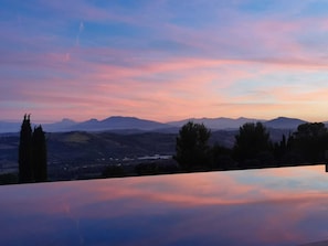 A panoramic view of a mountainous landscape with a clear sky.
