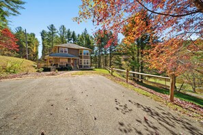 A two-story house with a porch and a driveway. - New River Overlook (West Jefferson)