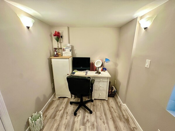 A small, compact room with a desk, chair, and a white radiator. - Toujours Pret N373 (Jensen Beach)