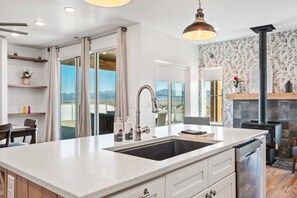 A kitchen with a large island, stainless steel appliances, and a view of the outdoors. - 405 Aspen Valley - Panguitch (Panguitch)