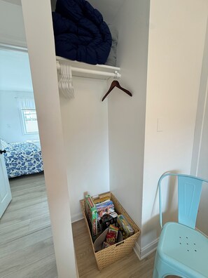 A bedroom with a bed, a wooden storage box, and a blue chair. - SLEEPS 5 WITH FULL KITCHEN & STEPS TO THE BEACH!! (Old Orchard Beach)