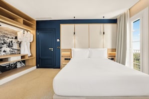 A hotel room with a large bed, wooden wardrobe, and a view of the outdoors. - Cais 68 Luxury Boutique Villa - Adults Only - 24h Concierge (Funchal)