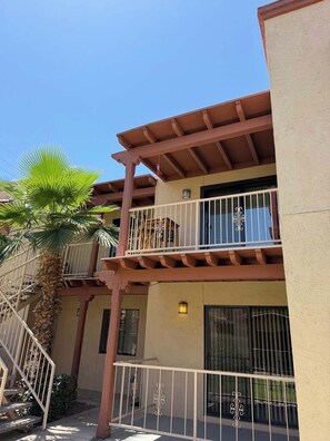 A multi-story building with balconies, a palm tree, and a staircase. - Quiet Tucson Hideout +pool +patio (Tucson)