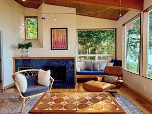 A living room with a fireplace, a sofa, a chair, and a coffee table.