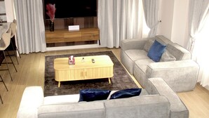 A modern living room with a flat-screen TV, grey sofas, a wooden coffee table, and a bar area with stools. - Peaceful 3-bedroom building with AC in vibrant Accra (Accra)