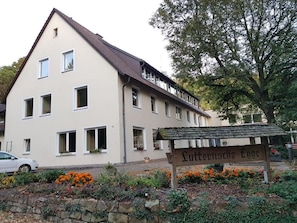 A two-story building with a sign reading 'Luttensteige Egge' in front. - Berghotel (Bad Oeynhausen)