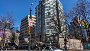 A multi-story building with a modern architectural design, featuring a curved facade and large windows. - 2 Bed 2 Bath Free Parking Downtown Vancouver (Vancouver)