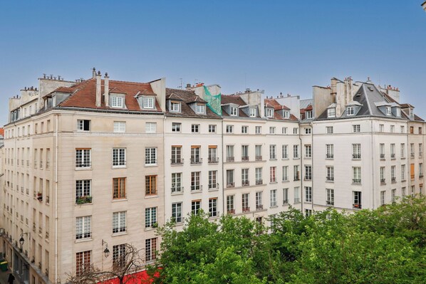 Ein mehrgeschossiges Gebäude mit gleichmäßigen Fensteranordnungen und Balkonen.