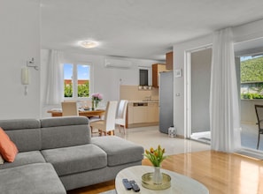 A modern apartment with a living room, dining area, kitchen, and a balcony with a view. - Three Bedroom Holiday Home with Private Pool and Terrace (Šibenik)