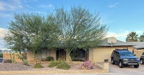 A residential house with a garage, a driveway, and a parked SUV. - 4-BEDROOM SPACIOUS HOME WITH A POOL, PERFECT FOR A FUN/RELAXING TIME IN ARIZONA (Glendale)