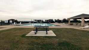 A swimming pool with lounge chairs, a picnic table, and a covered pavilion. - 4-bedroom/3 bath house in brilliant Georgetown with cool AC. (Georgetown)