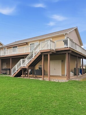 A two-story house with a covered porch, a staircase, and a garage.