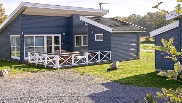 A modern two-story house with a covered porch and a gravel driveway. - 6 Person Holiday Park Home in Gudhjem (Gudhjem)
