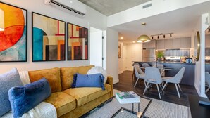 Ein modernes Wohnzimmer mit einer Couch, einem Couchtisch und abstrakter Kunst an der Wand.