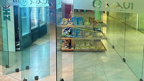 A glass-fronted store with a refrigeration unit and snack display.
