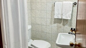 A bathroom with a toilet, sink, and two towels hanging on the wall. - Grand Memphis & Roof Top Restaurant (Luxor)