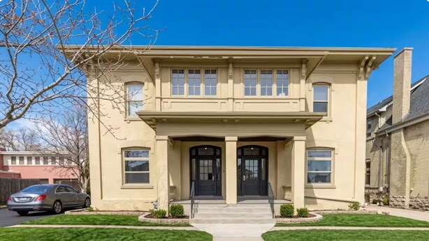 A two-story house with a front entrance, a driveway, and a lawn. - Cozy 2BR Apartment  Parking Included (London)