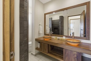A bathroom with two vessel sinks, a large mirror, and a dark tiled shower area. - One Bedroom Oceanfront - Puerto Escondido 1361 (Bajos de Chila)