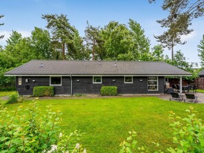 A single-story house with a tiled roof, a front porch, and a well-maintained lawn. - "Sissa" - 700m from the sea by Interhome (Væggerløse)