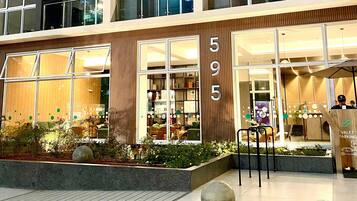 A modern building with a numbered facade, large windows, and outdoor seating.