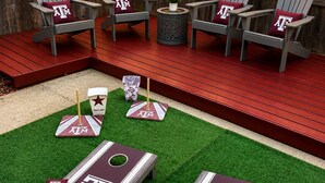 Un patio trasero con una terraza de madera, mobiliario exterior y un campo de mini golf.