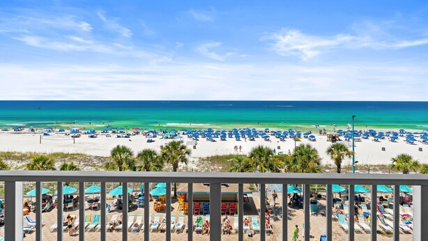 A beach with umbrellas and lounge chairs, a clear sky, and the ocean. - The Summit 518 - Beach Front, 2 Pools, & Hot Tubs (Panama City Beach)