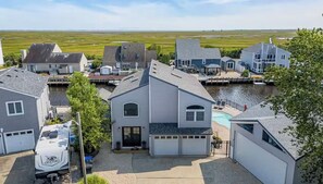 A residential area with houses, a dock, and a swimming pool. - Mallard Cove | 170' Waterfront, Pool & Hot Tub (Stafford Township)