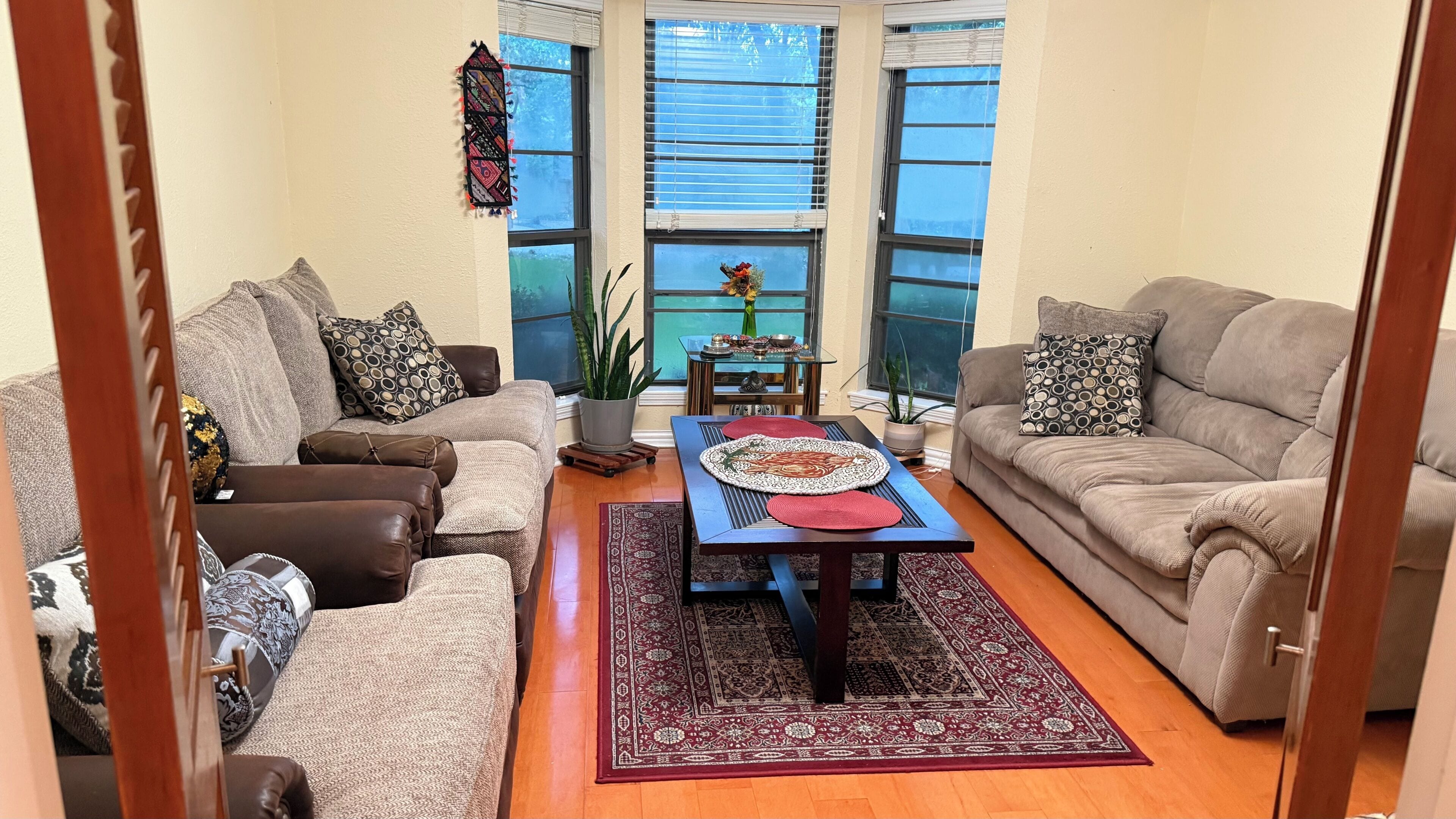 A living room with two sofas, a coffee table, and a rug.. Cozy 1-bedroom house in adorable Colleyville with AC