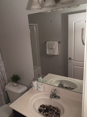 Un baño con lavabo, inodoro y espejo.