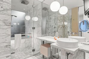 A modern bathroom with a glass-enclosed shower, two sinks, and a large mirror. - ONE OF NONE Studio @ Palms Place – 34th Floor Strip Views (Las Vegas)