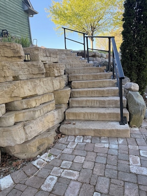 A stone staircase with metal railings leading up to a house. -  GrünHaus a peaceful private suite B&B in charming Frankenmuth (Frankenmuth)