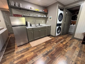 A kitchen with a refrigerator, sink, and washing machine. -  GrünHaus a peaceful private suite B&B in charming Frankenmuth (Frankenmuth)