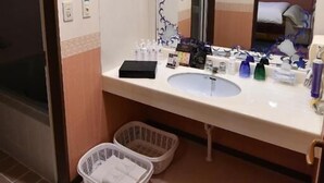 A bathroom with a sink, mirror, and two baskets. - hotel dolphia – Adults Only (Daisen)
