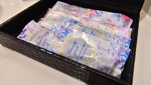 A black box containing several packages with floral designs and the text 'Amenity goods.' - hotel dolphia – Adults Only (Daisen)