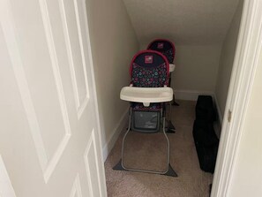 A narrow hallway with a baby stroller and a black bag on the floor. - Savannah Oasis: Huge 6BR Home w/Arcade & King Beds
Sleep 12, 9 beds, 6 BR, 3 BA (Pooler)