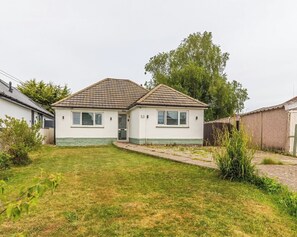 Ein eingeschossiges Haus mit Ziegeldach, einer Haustür und der Hausnummer 53 an der Wand.
