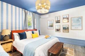 A bedroom with a bed, bedside table, lamp, and artwork on the wall. - Pool+HotTub+Pickleball+Game+Movie+PlayRoom+PetsOK (Barnstable)