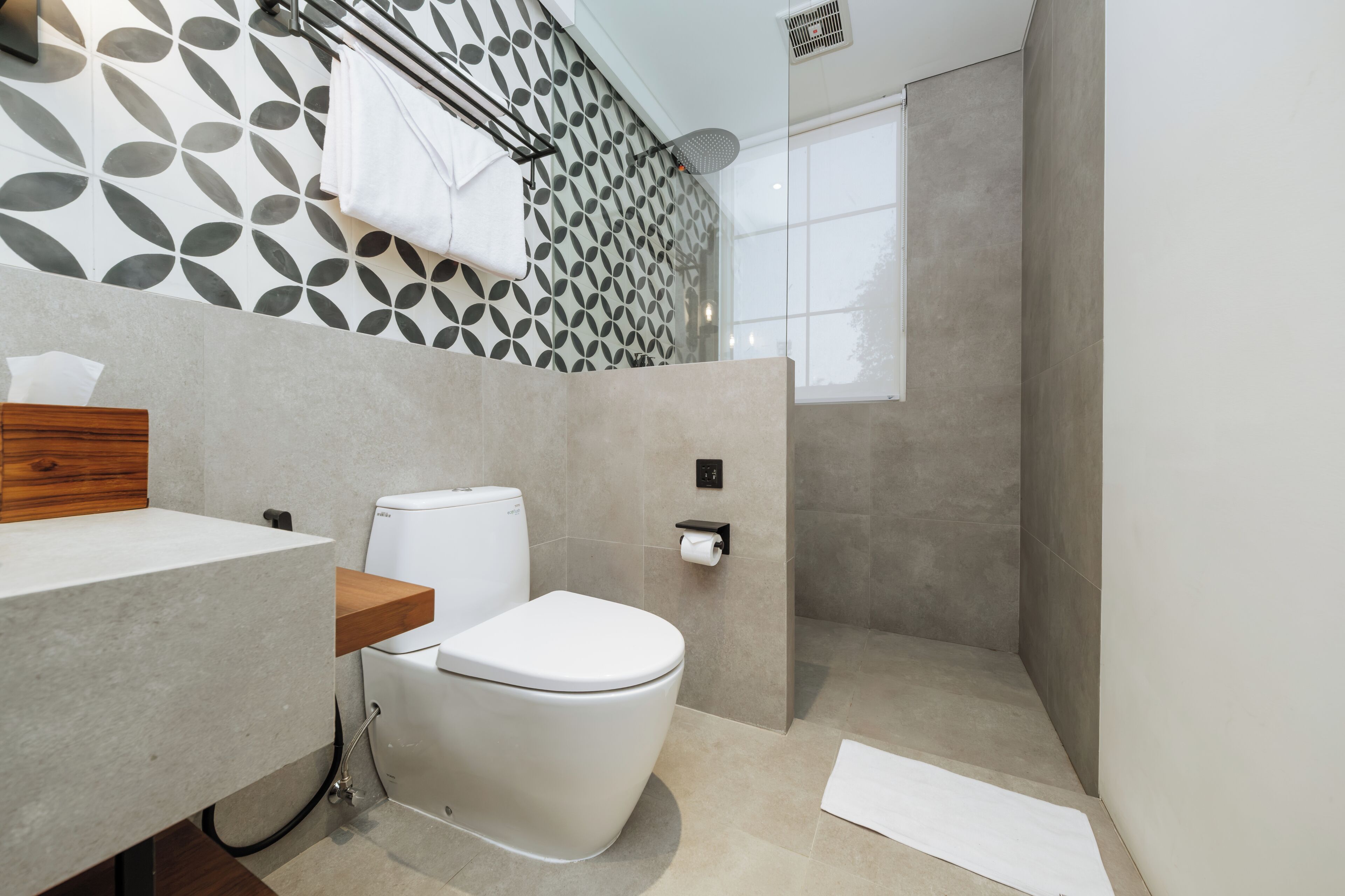 A modern bathroom with a toilet, sink, and shower.