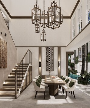 A modern interior with a staircase, a dining area with a pool view, and decorative lighting. - Nuho Living (Bingin, Uluwatu)