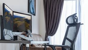 A modern office space with a desk, two monitors, a black office chair, a sofa, and a window with curtains. - FDS AIM (OSAKA/NISHINARIKU/TENGACHAYA)