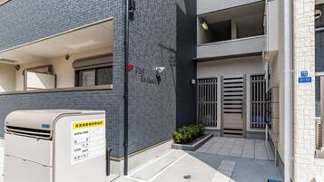 A building with a brick facade, a gated entrance, and a sign indicating a storage facility.