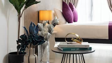 A modern living room with a round coffee table, a potted plant, a vase, and a lamp.