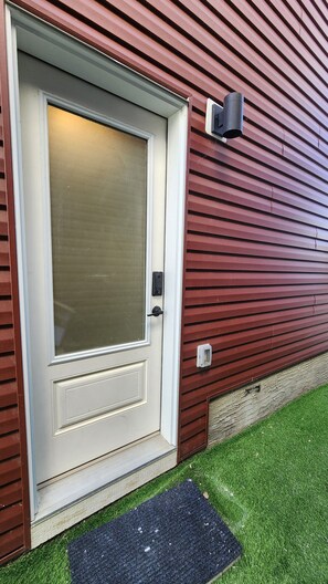 A house with a white door, a mailbox, and a small step leading to the door. - TNC Stays Cozy Luxurious Modern Suite with 85inch TV (Calgary)