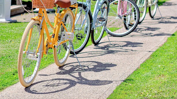 Bicycles parked on a sidewalk with a red building in the background. - Elevated French‑country coastal charm in the heart of Charlottetown (Charlottetown)