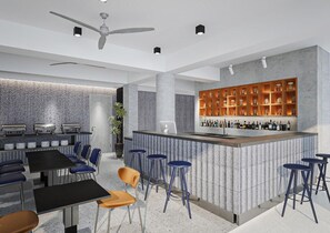A modern bar area with a counter, stools, and a seating area with tables and chairs. - Lantern Chiang Mai Night Bazaar Hotel (Chiang Mai)