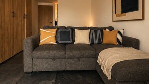 A modern living room with a sectional sofa, a large framed artwork, and a wooden wardrobe. - Roma Habitat. Loft in Roma Norte.
Designed for the modern traveler (Ciudad de México)