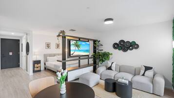 A modern living room with a TV, sofa, coffee table, and decorative items.