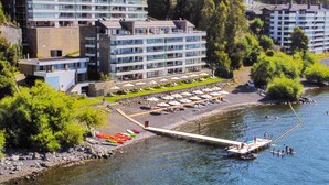 A riverside hotel with a dock, outdoor seating, and a view of the river. - Incredible apartment on the shores of Lake Villarrica!!! fully equipped!!! (Pucon)
