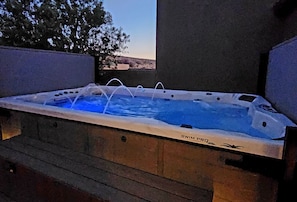 A hot tub with a view of the landscape.